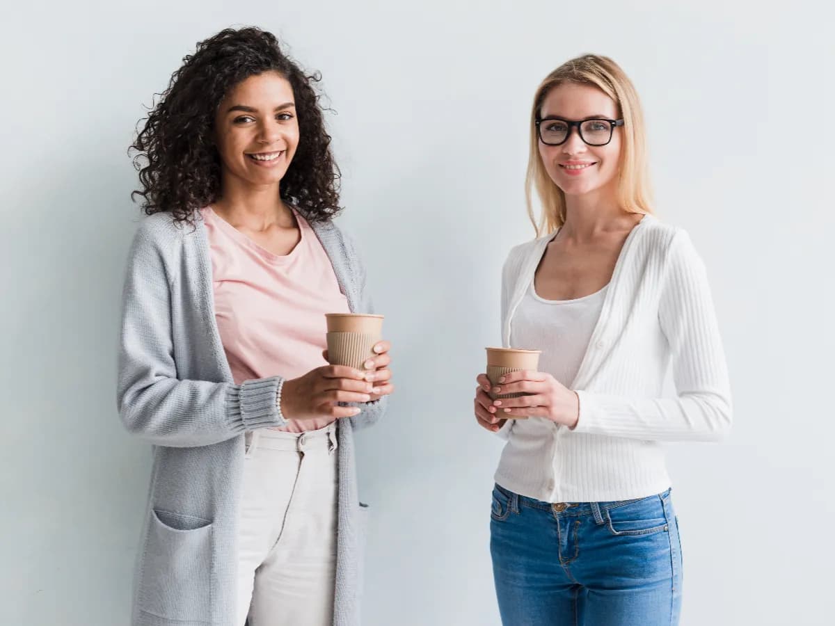blond-ethnic-coworkers-with-coffee-cups